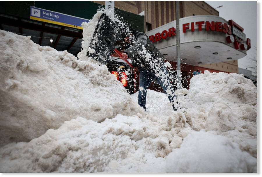 Click to enlarge worker clears snow from the entrance to a parking lot, as a major winter storm spreads across a large swath of the United States, in New York City, on Jan. 26, 2026.