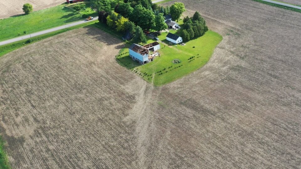 Scour marks in a field lead right to a barn with its roof torn off in Belmont, Ont. following a tornado on Wednesday, June 10, 2020.