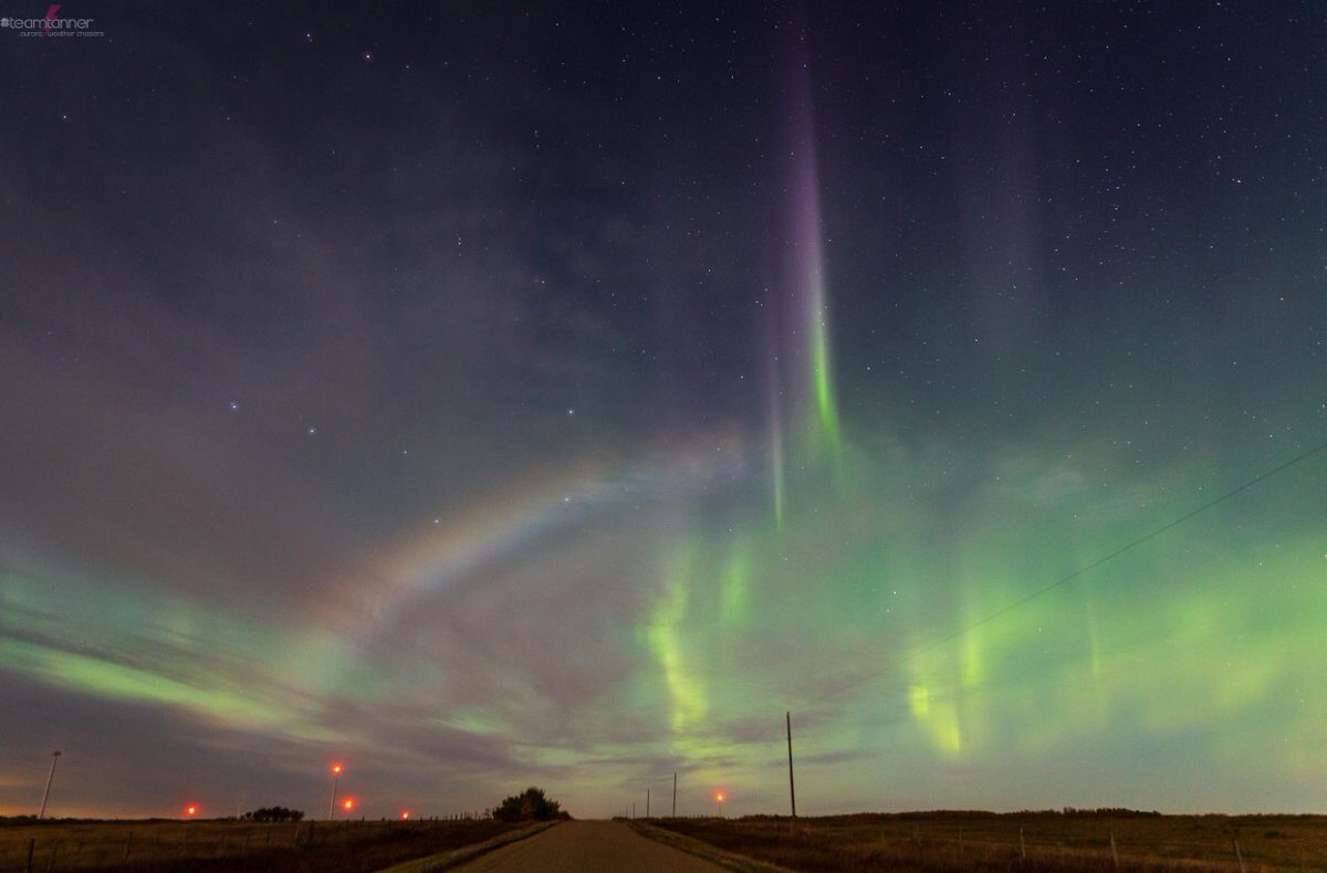 A moonbow appears against a backdrop of emerald-green northern lights over Castor, Alberta, on Sunday night