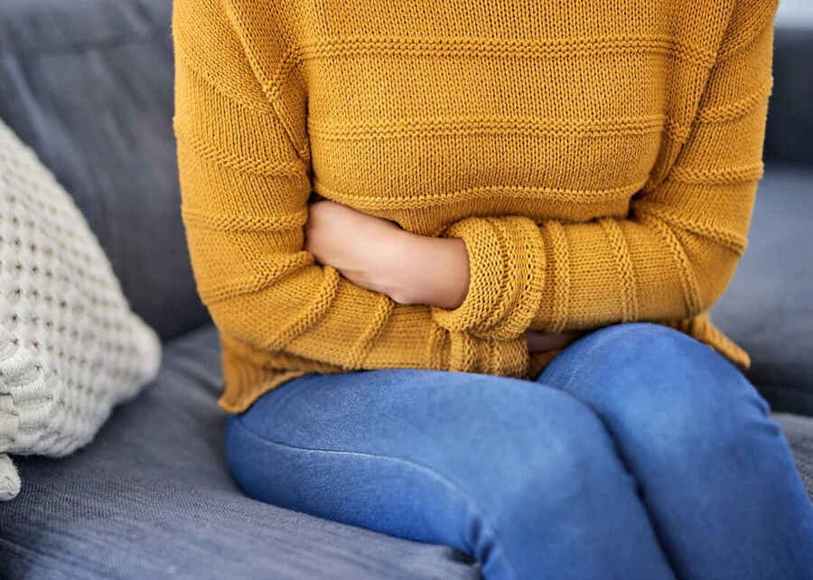 woman holding stomach, stomachache, upset tummy