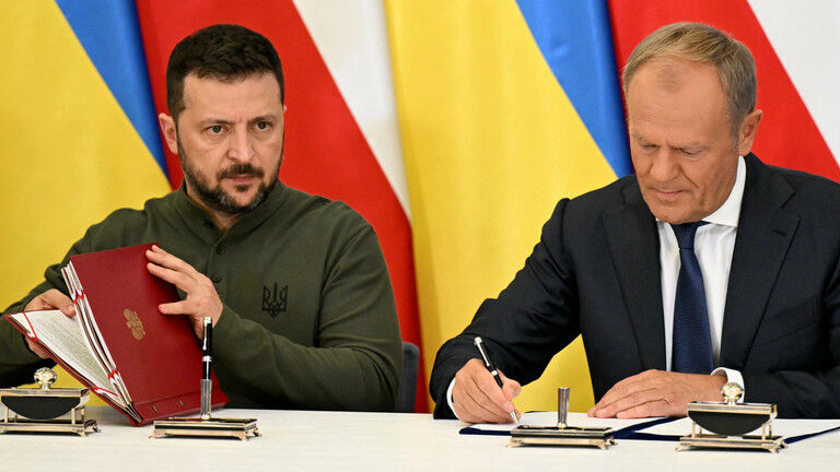 Vladimir Zelensky and Polish Prime Minister Donald Tusk sign an agreement during a meeting in Warsaw, Poland on July 8, 2024.