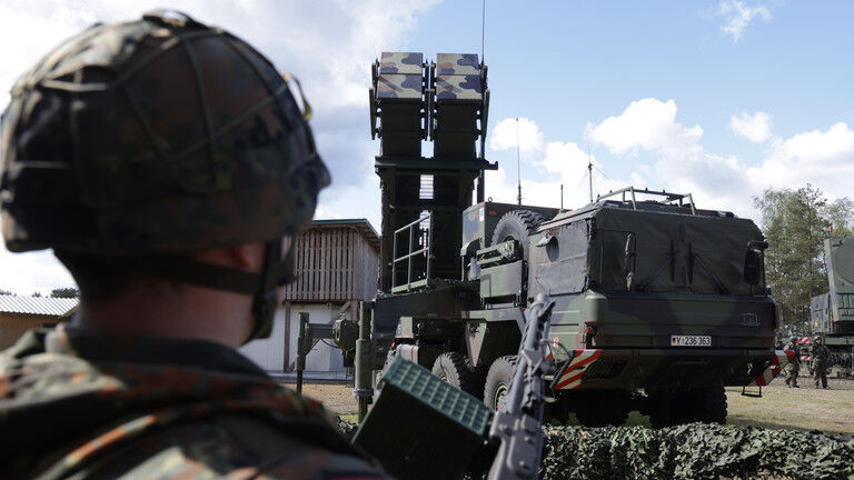 A reservist stands next to a launcher of a Patriot missile system in Munster, Germany on April 18, 2024