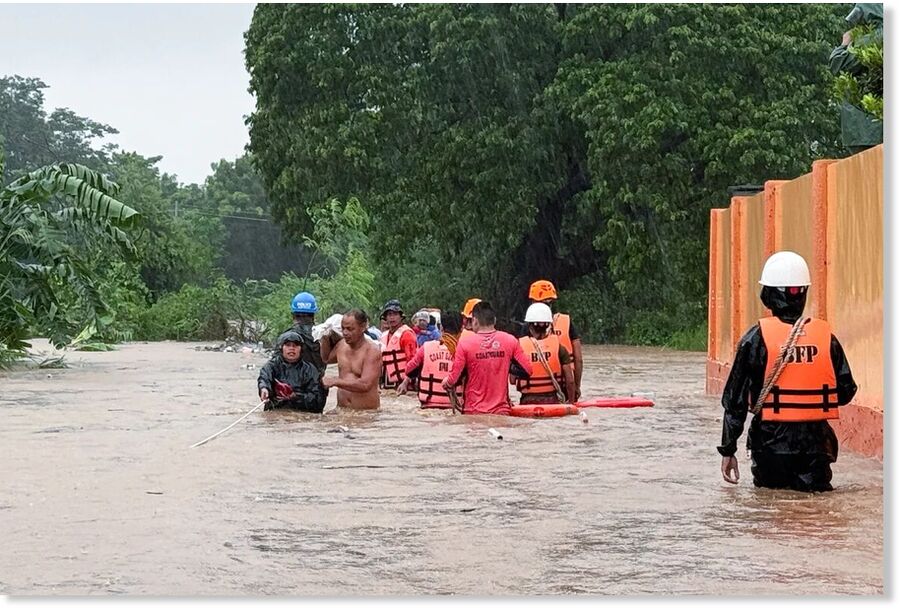 Rescuers help residents as they negotiate