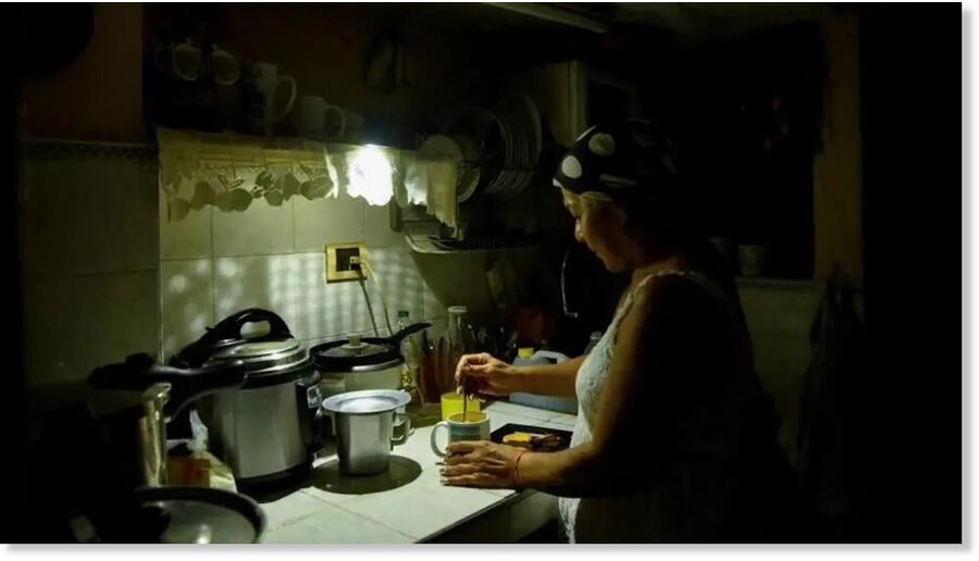 Havana resident Araselys Rodriguez makes coffee during the blackout