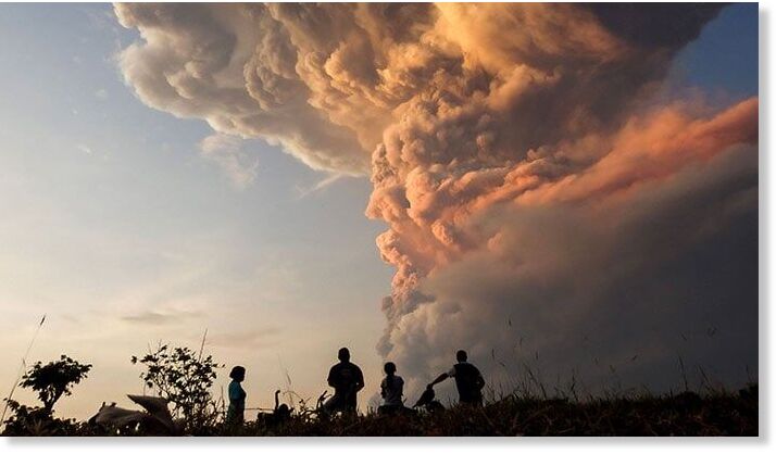 Residents watch the eruption of Mount Lewotobi Laki Laki from Lewolaga village in East Flores, East Nusa Tenggara on November 9, 2024.