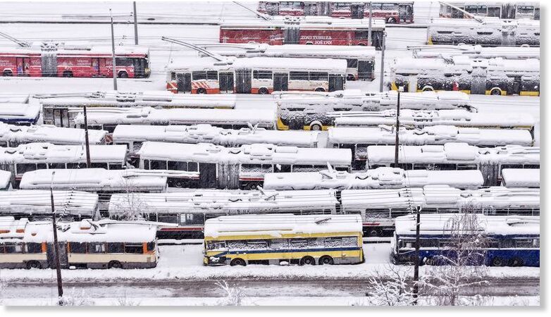 Parked buses covered in snow in Sarajevo, Bosnia.